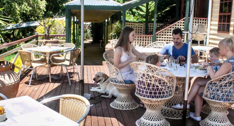 Group eating on the huge deck at The Manor Restaurant and Bar Tamborine Mountain